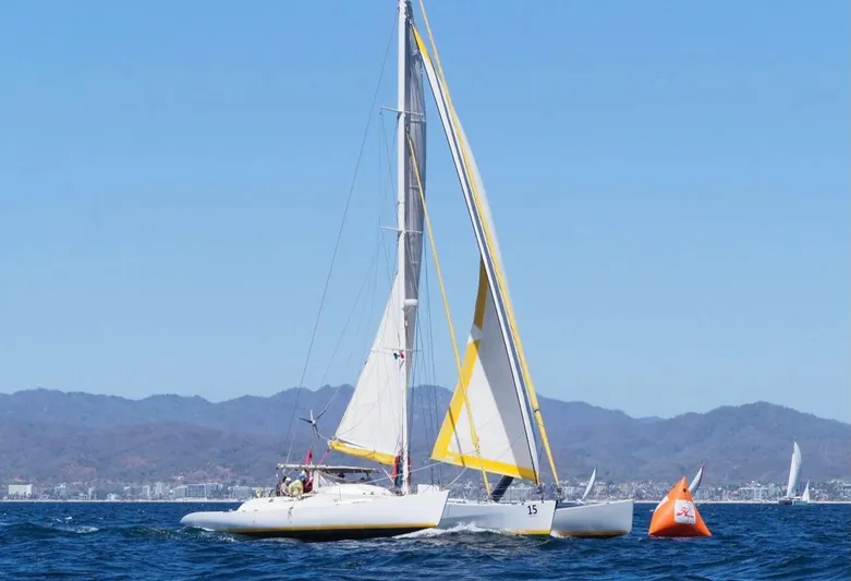 Koa E Kea Yacht Photos Pics Sailboat "Pinta Exception 53" from 1986 navigating near an orange buoy on a sunny day.