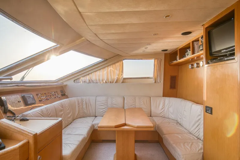 D-force Yacht Photos Pics Luxurious interior of 1998 Falcon Yachts 86 with plush seating and elegant wood finishes.
