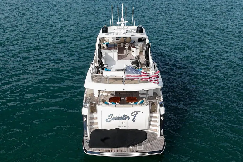 Sweeter T Yacht Photos Pics Princess 95 Motor Yacht 2011 on open water, rear view with American flag.