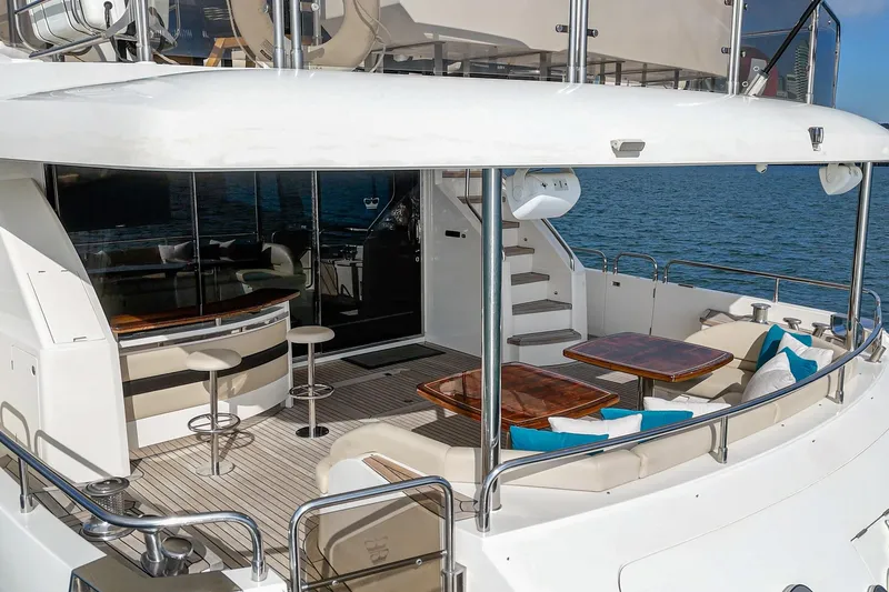 Sweeter T Yacht Photos Pics Luxurious 2011 Princess 95 Motor Yacht with elegant outdoor seating and bar area.