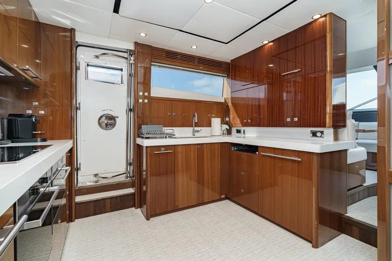 Sweeter T Yacht Photos Pics Luxurious kitchen interior of 2011 Princess 95 Motor Yacht with modern wood cabinetry.