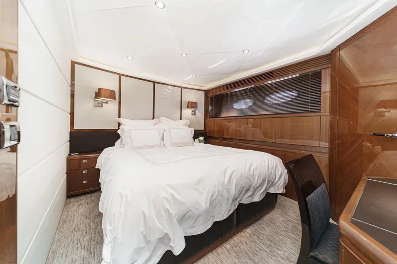Sweeter T Yacht Photos Pics Luxurious bedroom interior of 2011 Princess 95 Motor Yacht with elegant wood paneling.