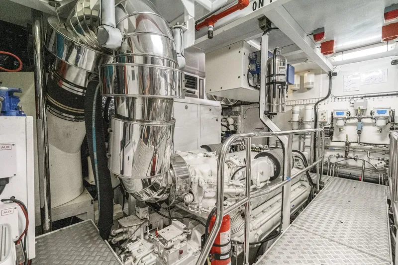 Sweeter T Yacht Photos Pics Engine room of 2011 Princess 95 Motor Yacht with polished metal components and machinery.
