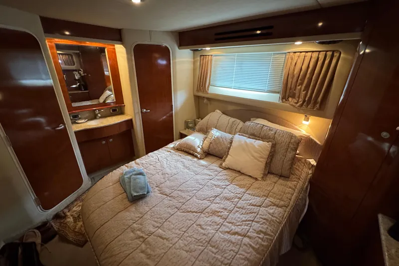 Marlys Kay Yacht Photos Pics Luxurious bedroom interior of 2004 Sea Ray 390 Motor Yacht with cozy bedding.