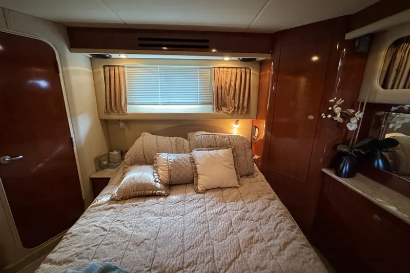 Marlys Kay Yacht Photos Pics Luxurious bedroom interior of 2004 Sea Ray 390 Motor Yacht with elegant wood finishes.