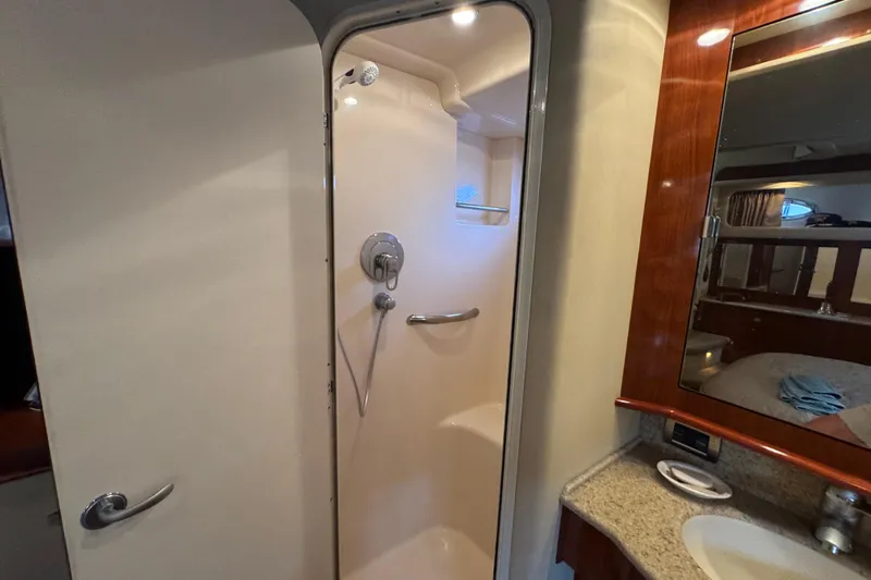 Marlys Kay Yacht Photos Pics Shower area in 2004 Sea Ray 390 Motor Yacht with modern fixtures and wooden cabinetry.
