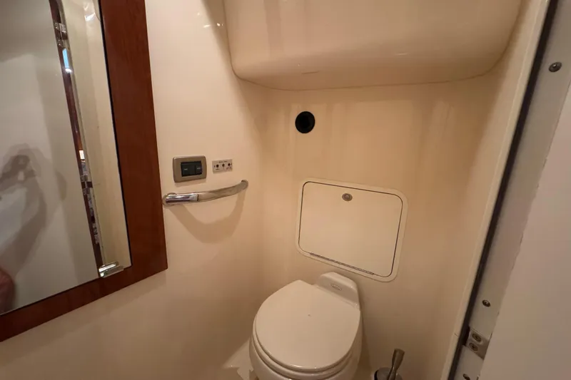 Marlys Kay Yacht Photos Pics Bathroom interior of 2004 Sea Ray 390 Motor Yacht, featuring toilet and mirror.