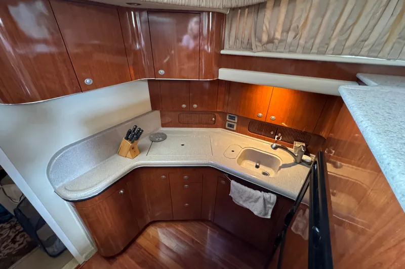 Marlys Kay Yacht Photos Pics Luxurious kitchen area in a 2004 Sea Ray 390 Motor Yacht with wood cabinetry.