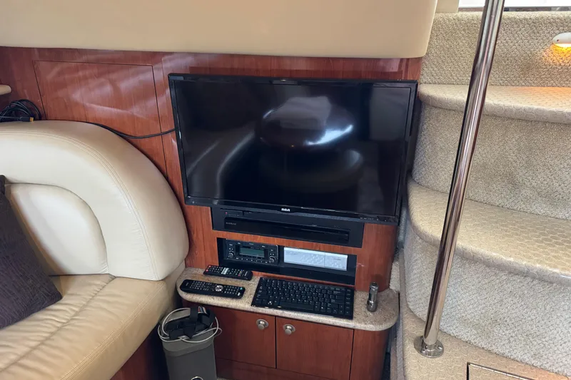 Marlys Kay Yacht Photos Pics Interior of 2004 Sea Ray 390 Motor Yacht with TV, stairs, and seating area.