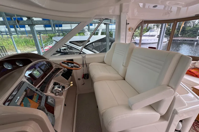 Marlys Kay Yacht Photos Pics 2004 Sea Ray 390 Motor Yacht helm with plush seating and modern controls.
