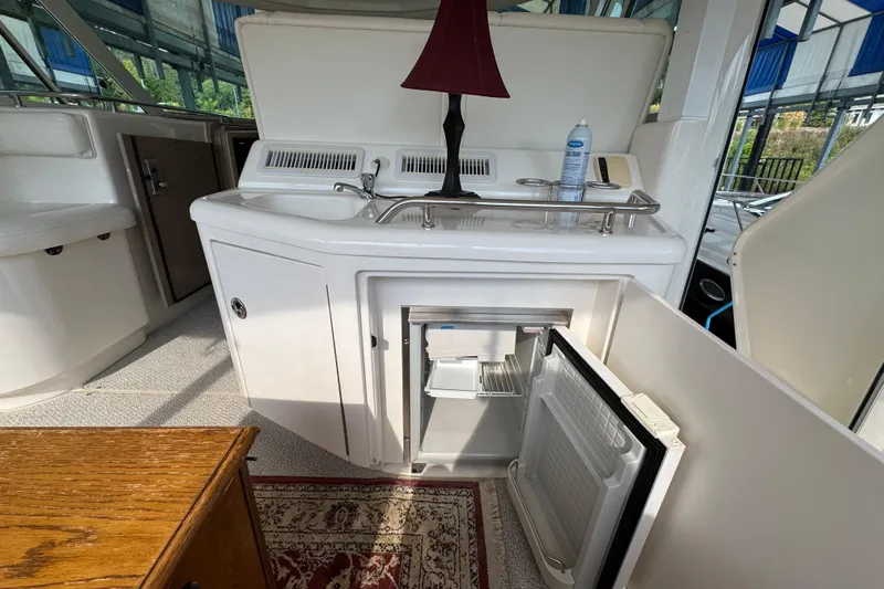 Marlys Kay Yacht Photos Pics 2004 Sea Ray 390 Motor Yacht interior with open mini fridge and sink area.