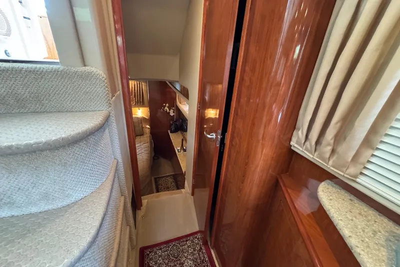 Marlys Kay Yacht Photos Pics Interior of 2004 Sea Ray 390 Motor Yacht with carpeted stairs and wooden finishes.