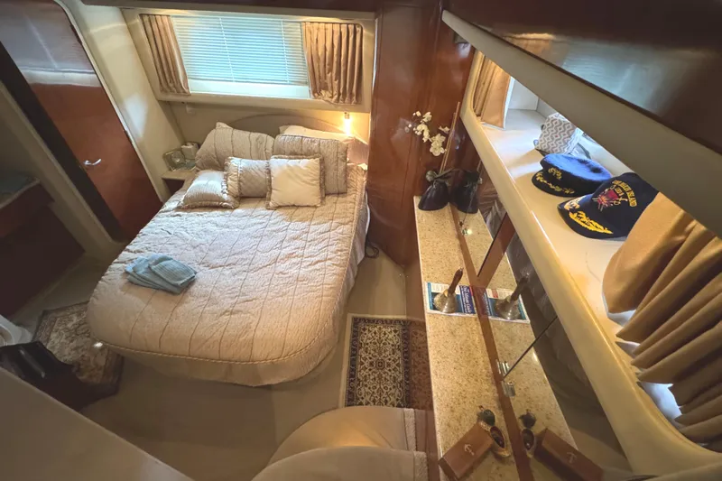 Marlys Kay Yacht Photos Pics Luxurious bedroom interior of 2004 Sea Ray 390 Motor Yacht with cozy bed and elegant decor.