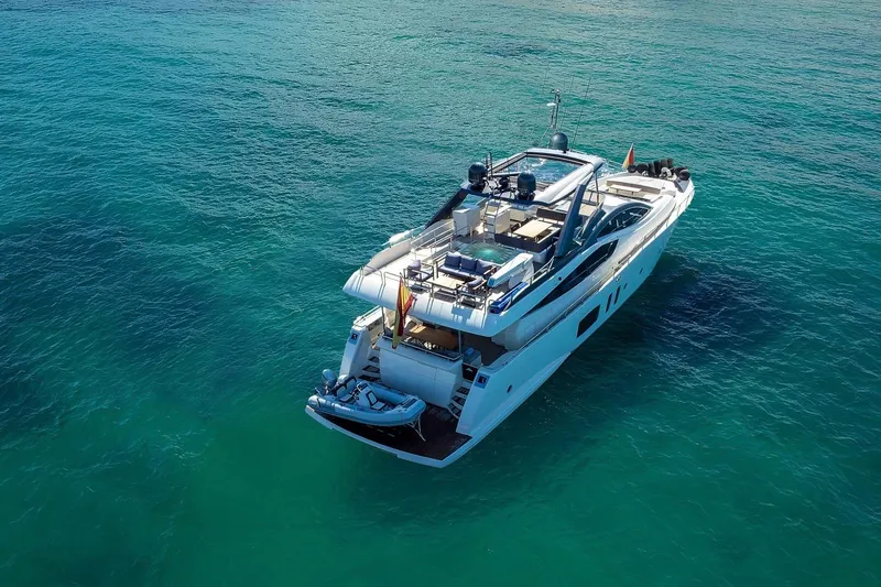  Yacht Photos Pics Luxury 2008 Astondoa 76 GLX yacht cruising on clear turquoise waters.