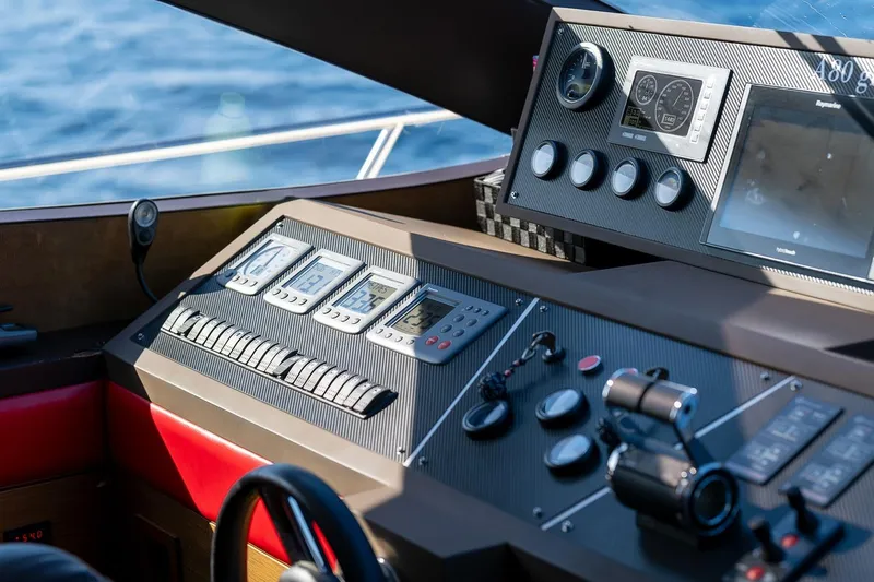  Yacht Photos Pics Control panel of 2008 Astondoa 76 GLX yacht with navigation instruments and steering wheel.