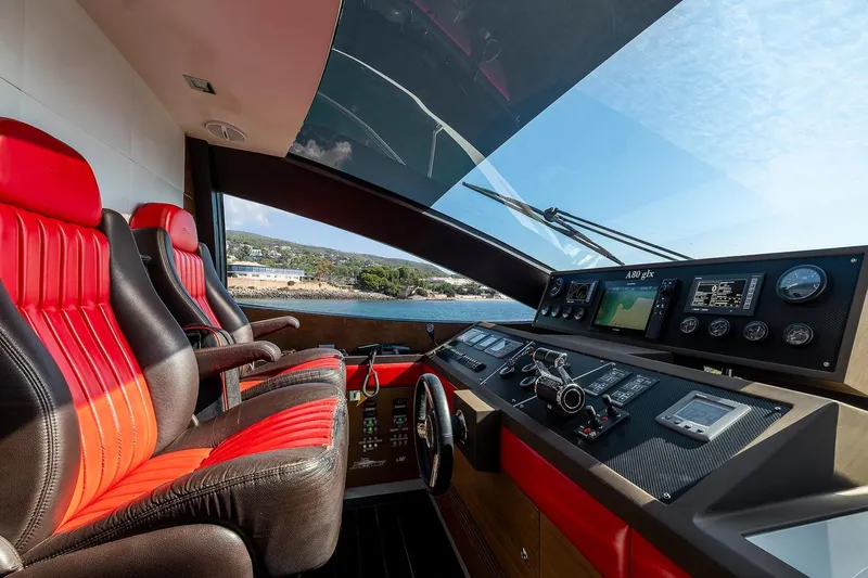  Yacht Photos Pics Interior view of 2008 Astondoa 76 GLX yacht cockpit with red and black seats.