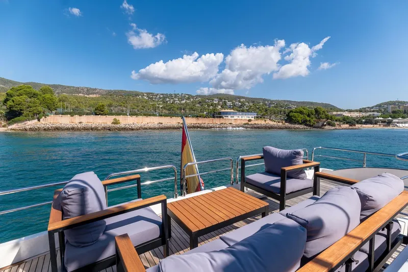  Yacht Photos Pics Luxury deck view on 2008 Astondoa 76 GLX yacht, overlooking serene coastal landscape.