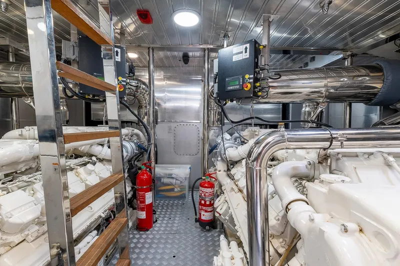  Yacht Photos Pics Engine room of 2008 Astondoa 76 GLX yacht with machinery and fire extinguishers.