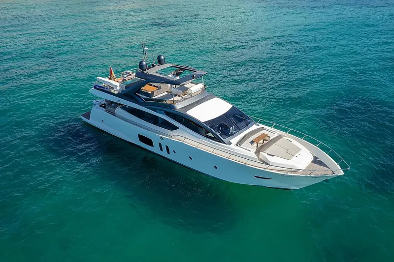  Yacht Photos Pics Luxurious 2008 Astondoa 76 GLX yacht cruising on clear turquoise waters.