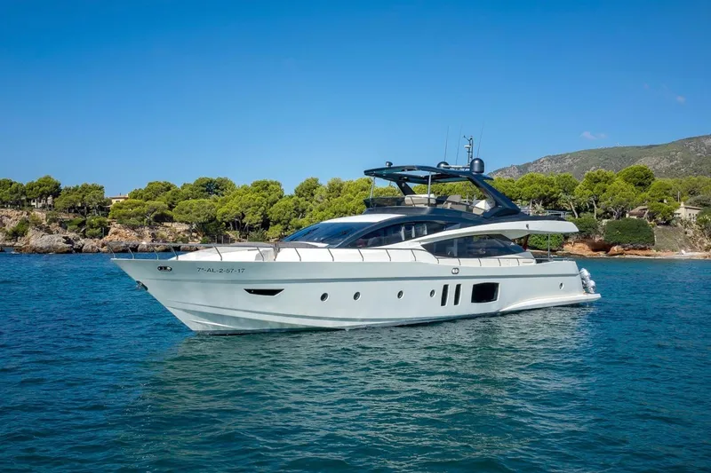  Yacht Photos Pics 2008 Astondoa 76 GLX yacht cruising on clear blue water near a scenic coastline.