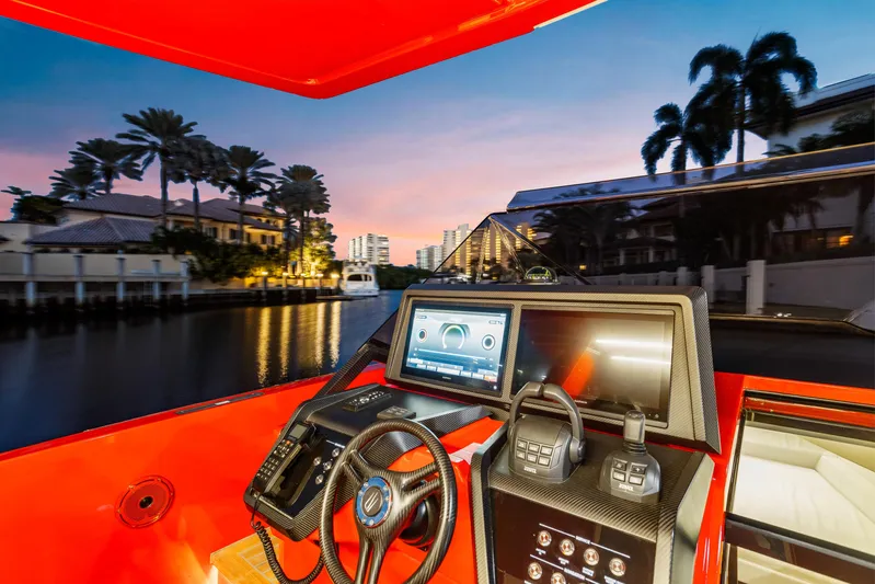  Yacht Photos Pics Modern Wally 48 yacht cockpit with advanced navigation system, vibrant sunset, and waterfront view.