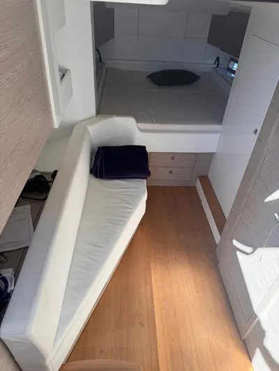  Yacht Photos Pics Interior of 2024 SACS Rebel 47 yacht with modern seating and wooden flooring.