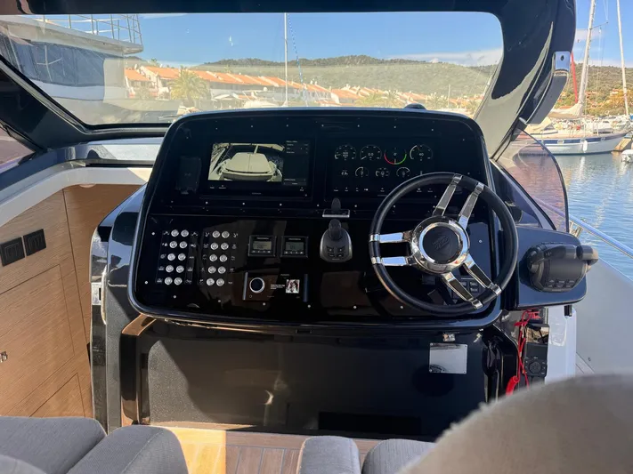  Yacht Photos Pics 2024 SACS Rebel 47 helm with modern controls and sleek steering wheel.