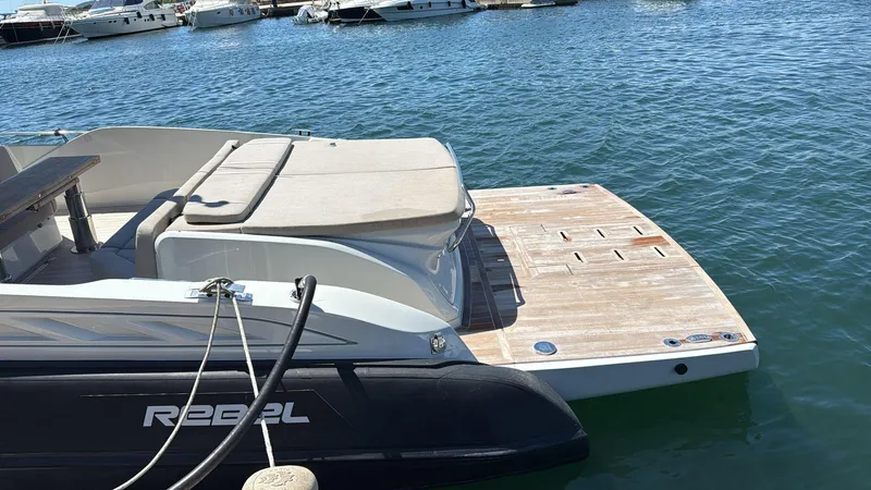  Yacht Photos Pics 2024 SACS Rebel 47 yacht docked, featuring a spacious sun deck and sleek design.