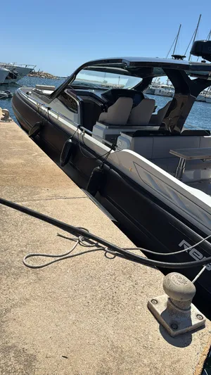  Yacht Photos Pics 2024 SACS Rebel 47 yacht docked at marina under clear blue sky.