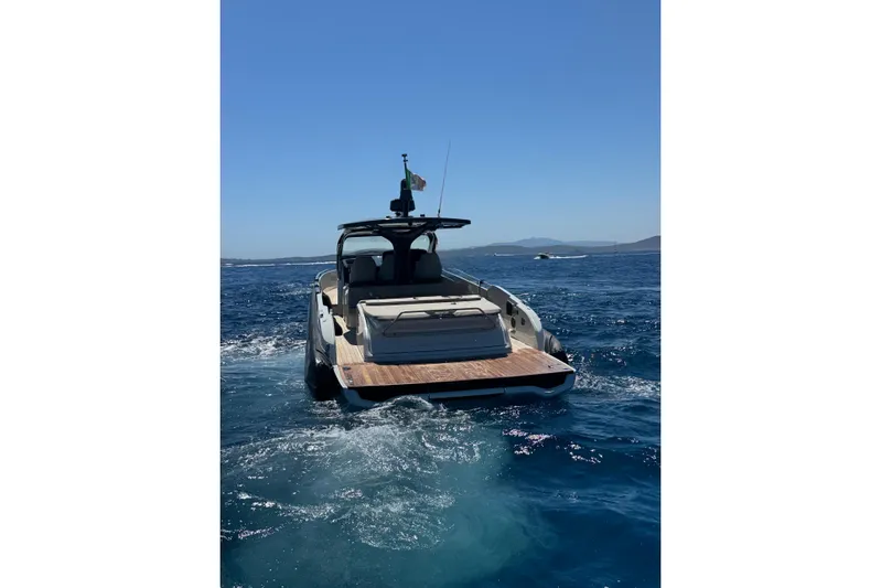  Yacht Photos Pics 2024 SACS Rebel 47 yacht cruising on open sea under clear blue sky.