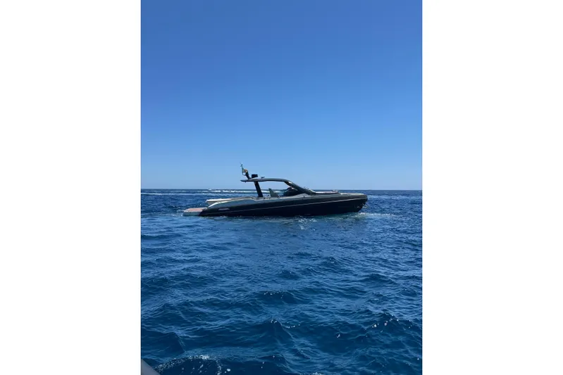  Yacht Photos Pics 2024 SACS Rebel 47 yacht cruising on open blue sea under clear sky.