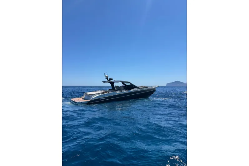  Yacht Photos Pics 2024 SACS Rebel 47 yacht cruising on clear blue ocean waters.