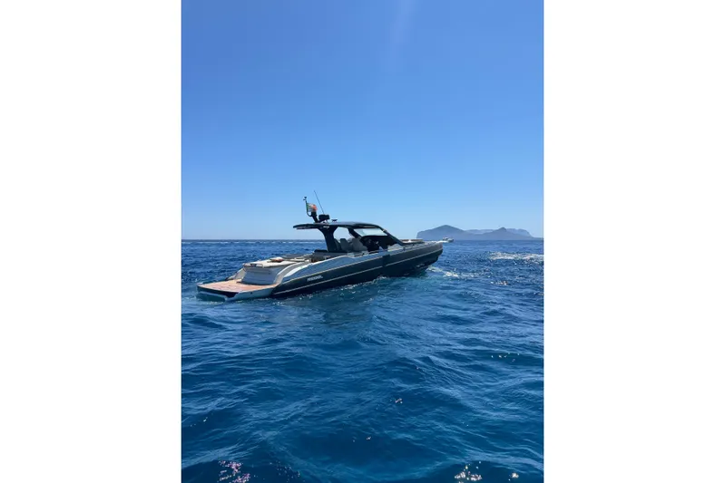  Yacht Photos Pics 2024 SACS Rebel 47 yacht cruising on clear blue ocean waters.