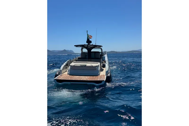  Yacht Photos Pics 2024 SACS Rebel 47 yacht cruising on open sea under clear blue sky.