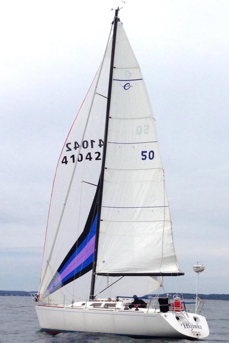 Sailboat Express 37, 1986 model, sailing on open water with white sails.