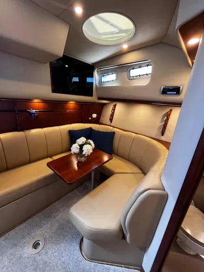 Christine Elizabeth Yacht Photos Pics Luxurious 2002 Rampage 38 Express yacht interior with elegant seating and table.