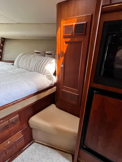 Christine Elizabeth Yacht Photos Pics 2002 Rampage 38 Express cabin interior with bed, wood paneling, and seating.