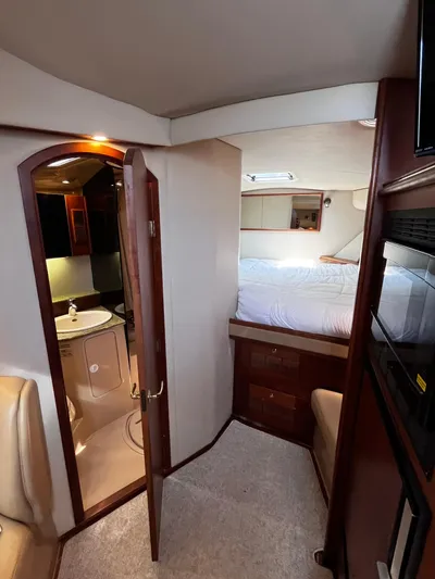 Christine Elizabeth Yacht Photos Pics Interior of 2002 Rampage 38 Express yacht, featuring cozy bedroom and bathroom.