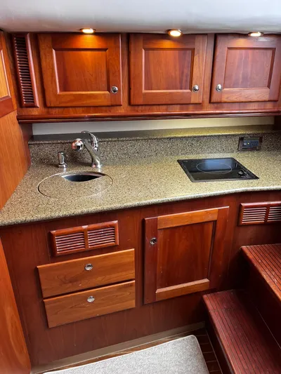 Christine Elizabeth Yacht Photos Pics 2002 Rampage 38 Express yacht kitchen with wood cabinets and granite countertop.