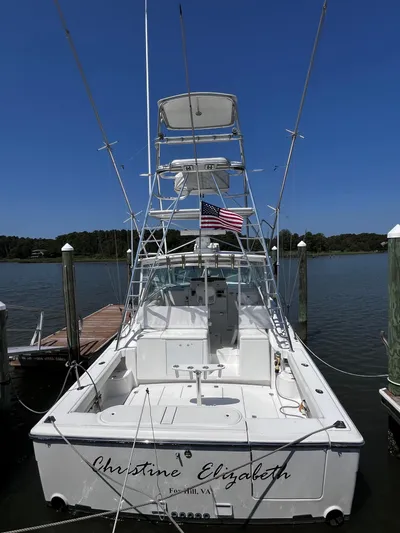 Christine Elizabeth Yacht Photos Pics 2002 Rampage 38 Express boat docked, rear view with American flag.