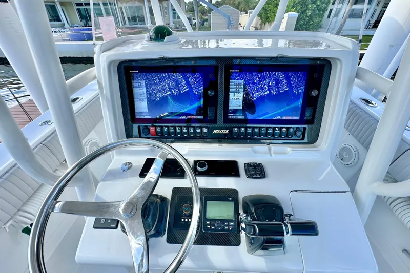  Yacht Photos Pics Helm of 2006 Jupiter 31FS boat with dual navigation screens and steering wheel.