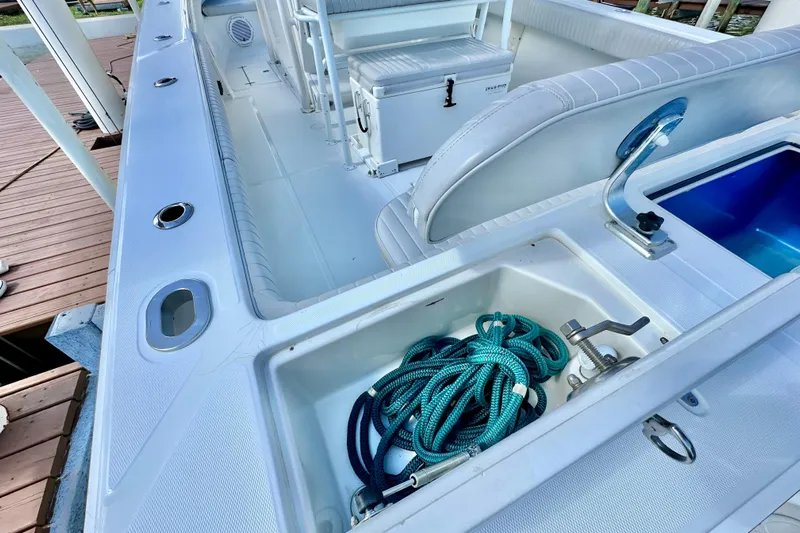  Yacht Photos Pics 2006 Jupiter 31FS boat deck with storage compartment and coiled rope.