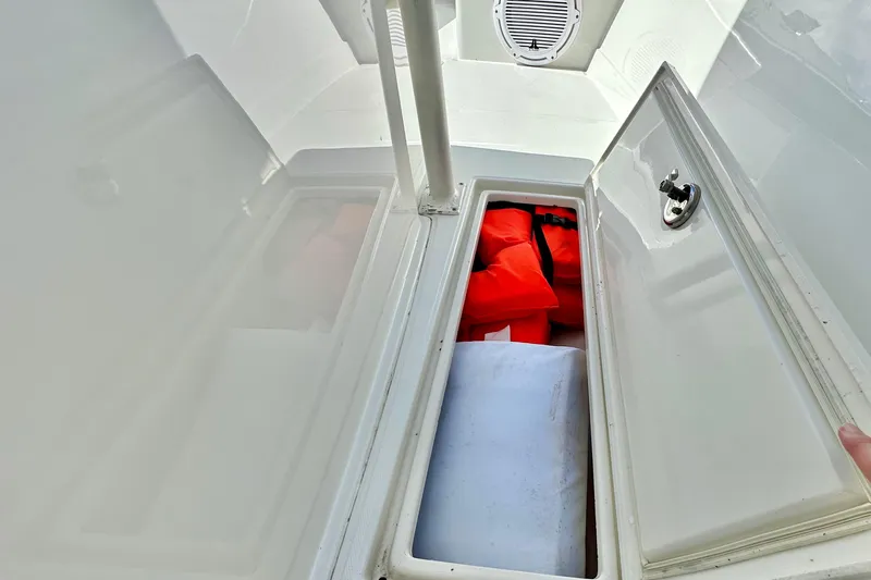  Yacht Photos Pics Storage compartment in 2006 Jupiter 31FS boat with life jackets and equipment.