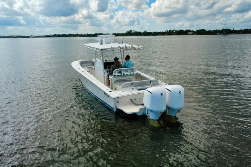  Yacht Photos Pics 2006 Jupiter 31FS boat on calm water with two people onboard.