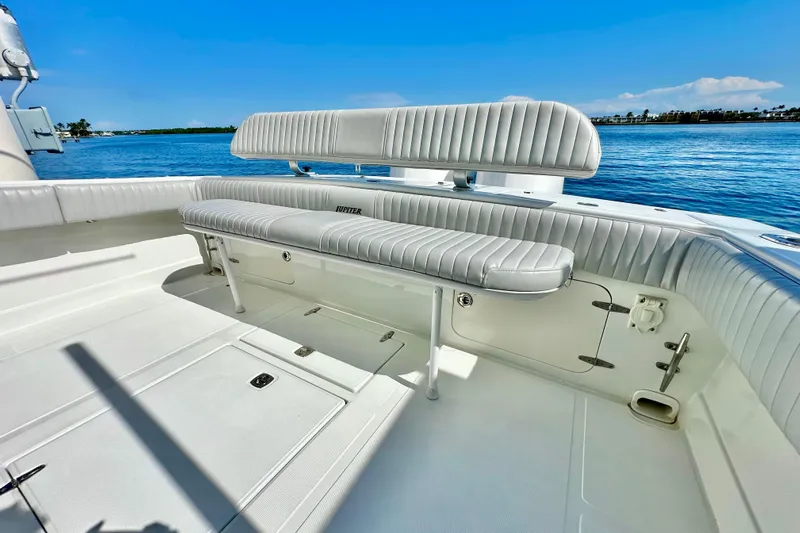  Yacht Photos Pics 2006 Jupiter 31FS boat interior with white seating, on calm blue water.