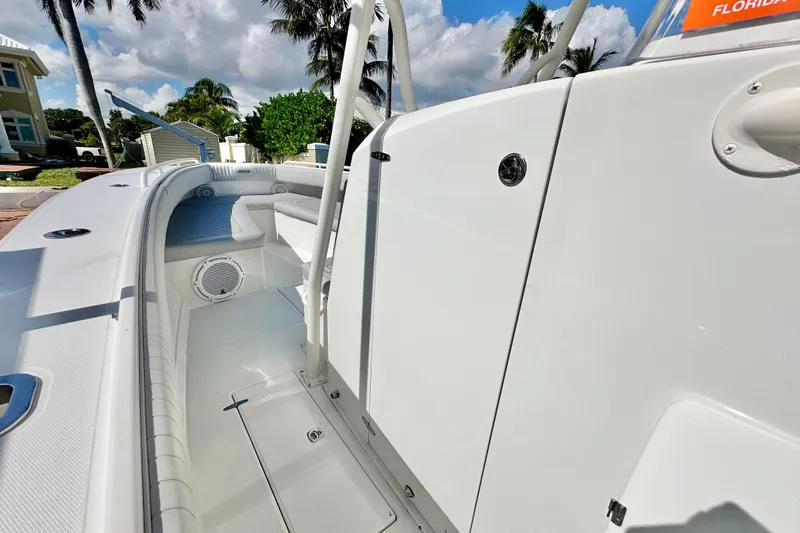  Yacht Photos Pics 2006 Jupiter 31FS boat interior with seating, speaker, and storage, under a sunny sky.