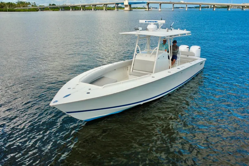  Yacht Photos Pics 2006 Jupiter 31FS boat on calm water near a bridge.