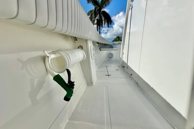  Yacht Photos Pics 2006 Jupiter 31FS boat deck with coiled hose and palm trees in background.