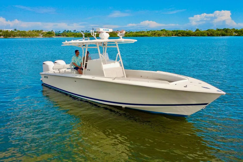  Yacht Photos Pics 2006 Jupiter 31FS boat on calm blue water under clear sky.