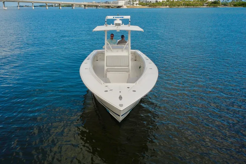  Yacht Photos Pics 2006 Jupiter 31FS boat on calm water with bridge in background.